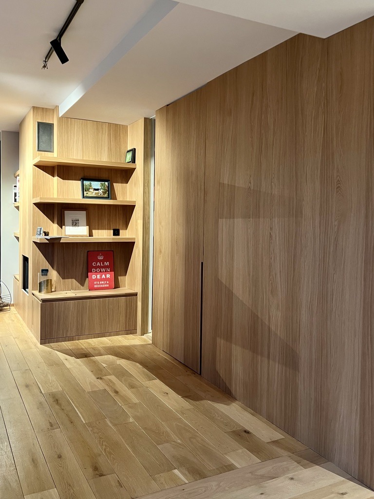 Oak shelving around the fireplace and full-height oak wall panelling