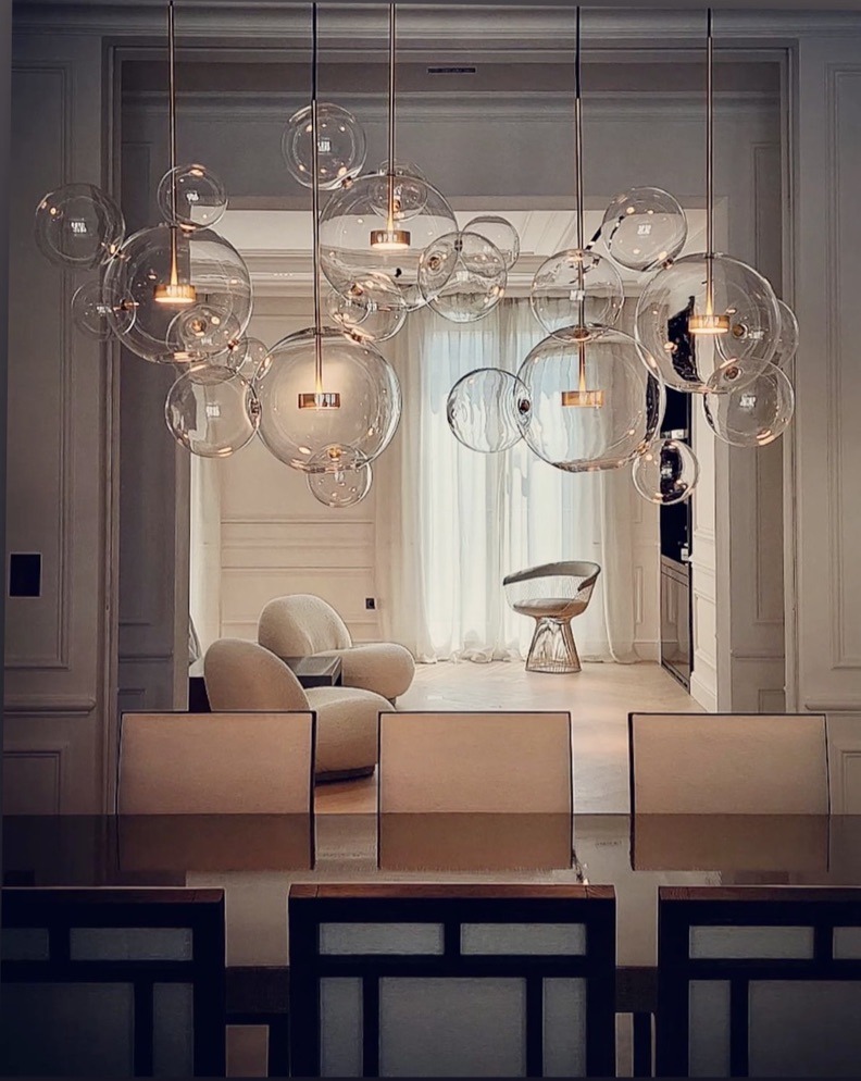 Dining room with glass bubble pendants, view through to the living room