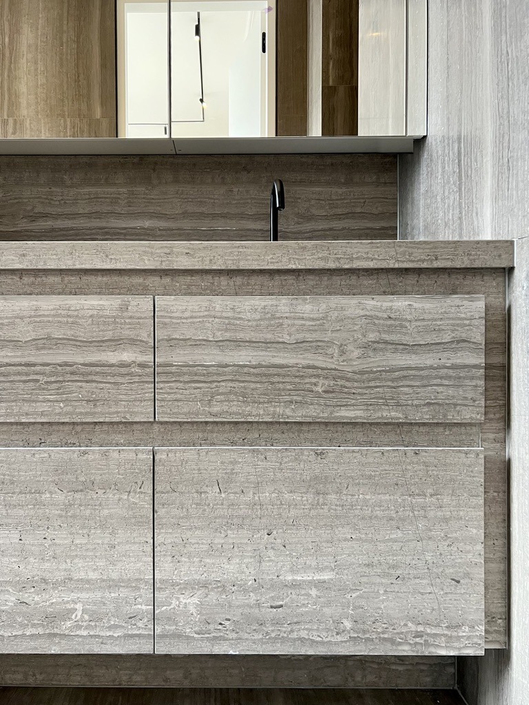 Bathroom vanity in veined grey stone, black tap